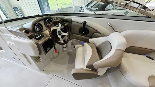 Slide: The Image of Interior of a 2014 Crownline 255 SS boat with steering wheel and seats. - 12