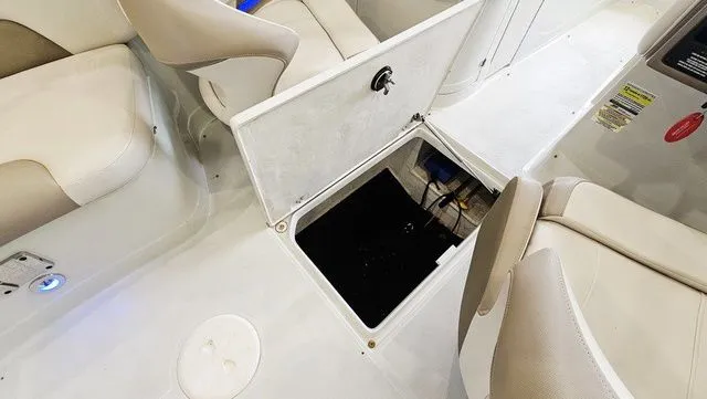 Slide: The Image of Interior of a 2014 Crownline 255 SS boat with open storage compartment. - 23