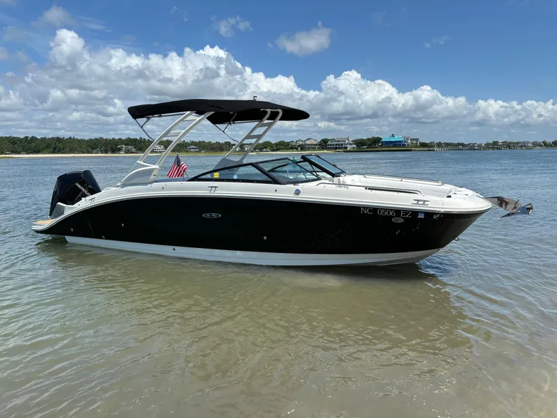 Slide: The Image of 2023 Sea Ray SDX 270 Outboard boat anchored in shallow water on a sunny day. - 0