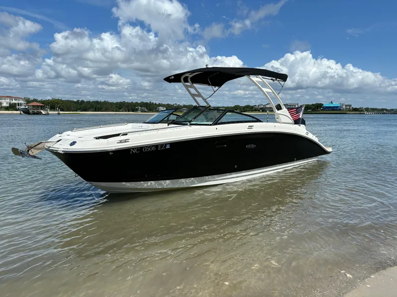 Slide: The Image of 2023 Sea Ray SDX 270 Outboard boat anchored in shallow water. - 1