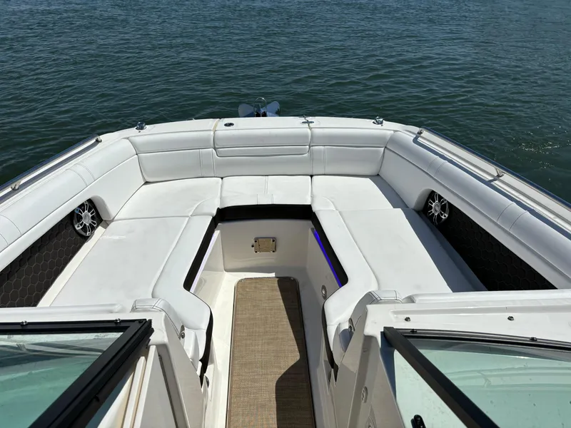 Slide: The Image of 2023 Sea Ray SDX 270 Outboard boat with spacious white seating and water view. - 11