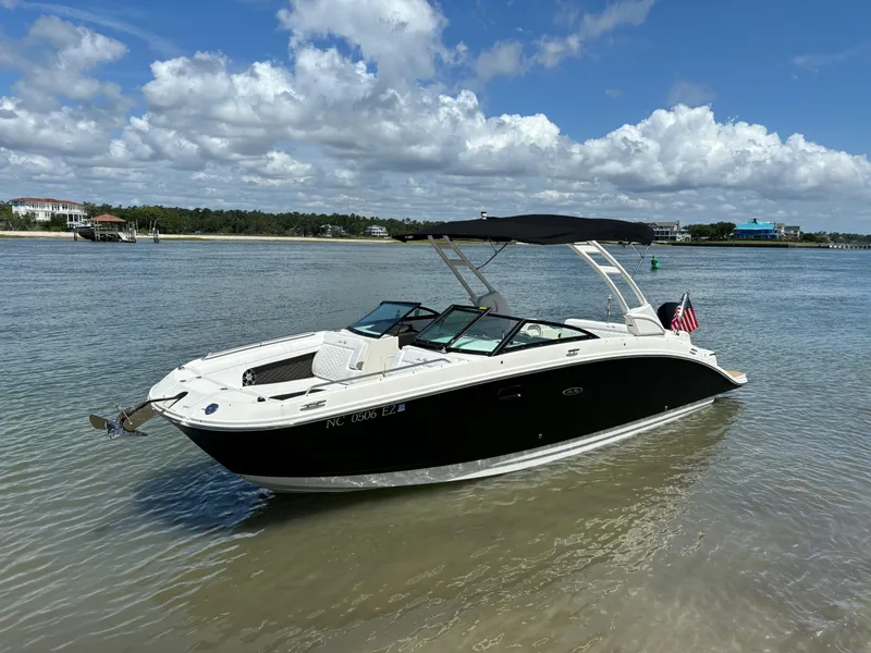 Slide: The Image of 2023 Sea Ray SDX 270 Outboard boat on calm water with scenic background. - 2