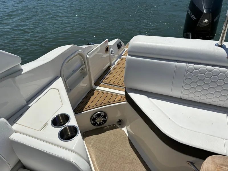 Slide: The Image of 2023 Sea Ray SDX 270 Outboard boat interior with white seating and cup holders. - 21