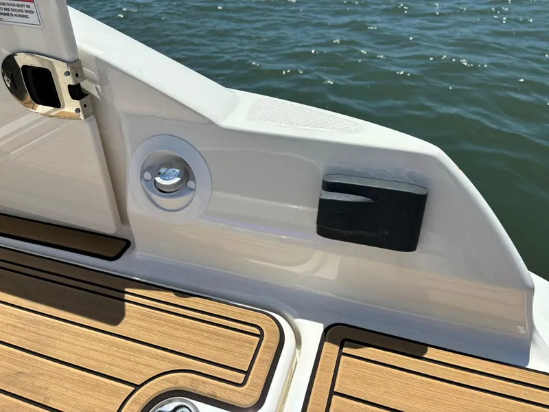 Slide: The Image of 2023 Sea Ray SDX 270 Outboard boat deck with wood finish and water view. - 24