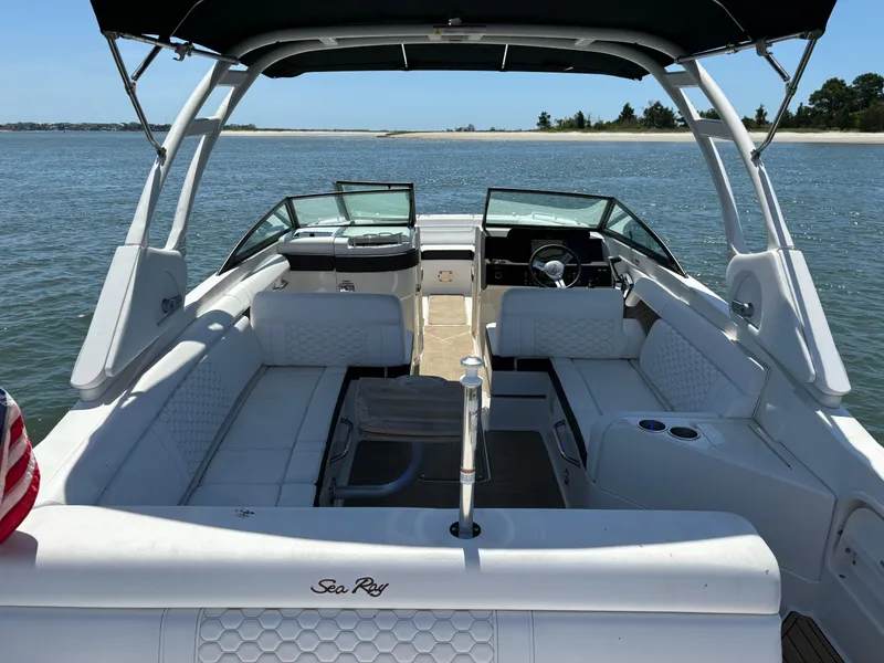Slide: The Image of 2023 Sea Ray SDX 270 Outboard boat interior with white seating on the water. - 25