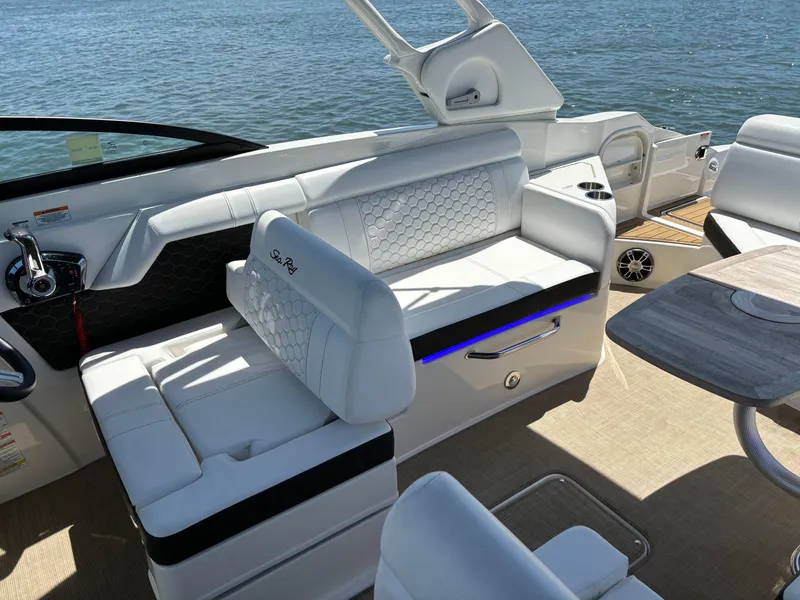 Slide: The Image of 2023 Sea Ray SDX 270 Outboard interior with white seating and water view. - 31