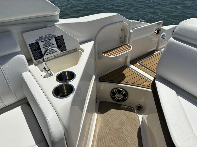 Slide: The Image of 2023 Sea Ray SDX 270 Outboard boat interior with sink, cup holders, and teak flooring. - 34