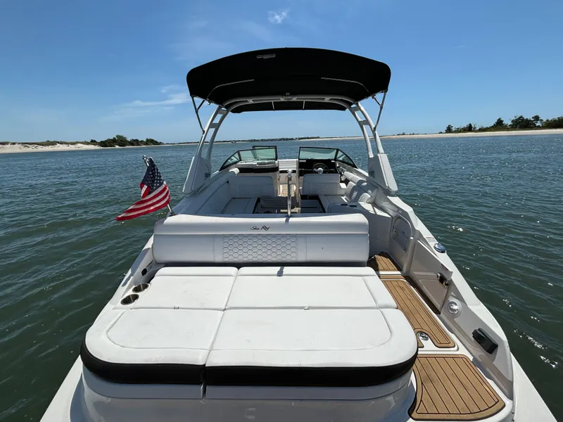 Slide: The Image of 2023 Sea Ray SDX 270 Outboard boat on water with American flag. - 35