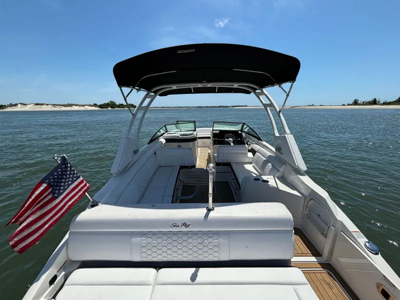 Slide: The Image of 2023 Sea Ray SDX 270 Outboard boat on water with American flag. - 37