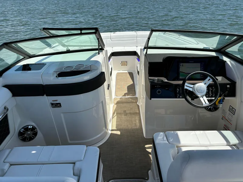 Slide: The Image of 2023 Sea Ray SDX 270 Outboard boat interior with steering wheel and seating, on the water. - 39