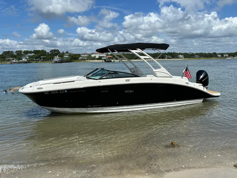 Slide: The Image of 2023 Sea Ray SDX 270 Outboard boat anchored near a sandy shore on a sunny day. - 4