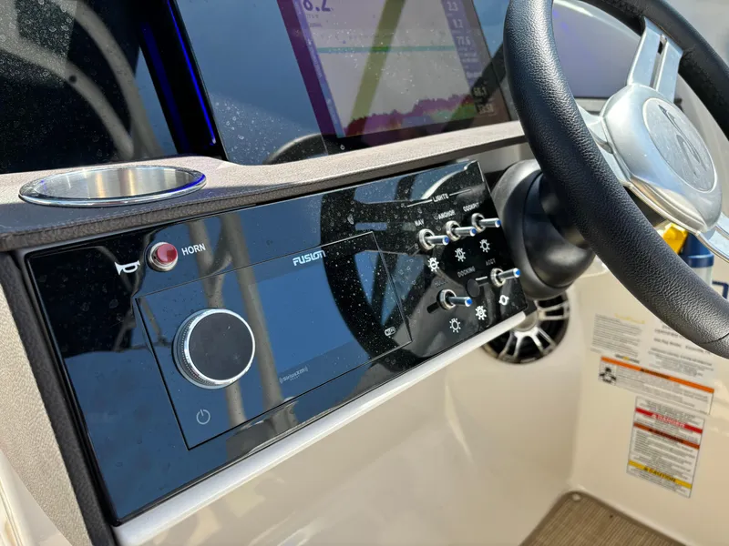 Slide: The Image of Close-up of the 2023 Sea Ray SDX 270 Outboard dashboard and steering wheel. - 47