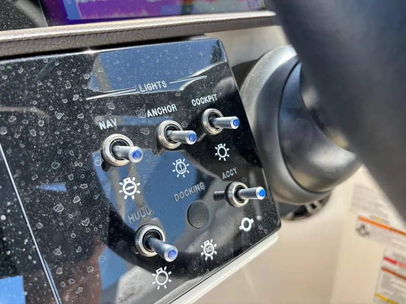 Slide: The Image of Close-up of 2023 Sea Ray SDX 270 Outboard control panel with switches. - 48