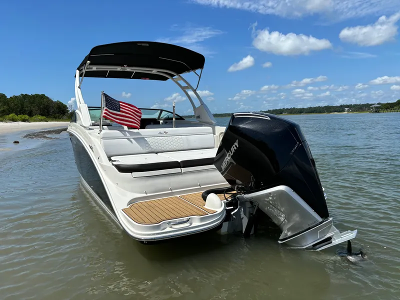Slide: The Image of 2023 Sea Ray SDX 270 Outboard boat anchored near a sandy beach. - 9