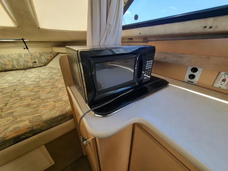 Slide: The Image of Interior of 2000 Bayliner 2859 Ciera Express with microwave and bed. - 10