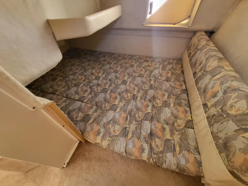 Slide: The Image of Interior cabin of 2000 Bayliner 2859 Ciera Express with patterned bedding. - 11