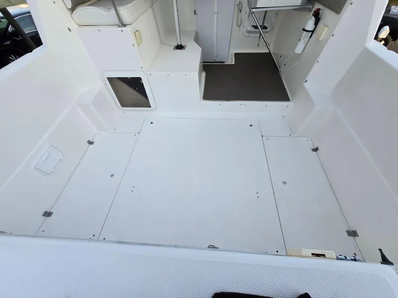 Slide: The Image of Bayliner 2859 Ciera Express 2000 model, spacious white deck interior. - 13