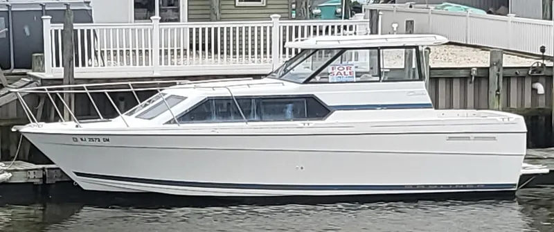 Slide: The Image of 2000 Bayliner 2859 Ciera Express boat docked, white exterior, "For Sale" sign visible. - 24