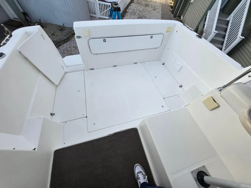 Slide: The Image of 2000 Bayliner 2859 Ciera Express boat deck, spacious and clean, with white seating and flooring. - 29