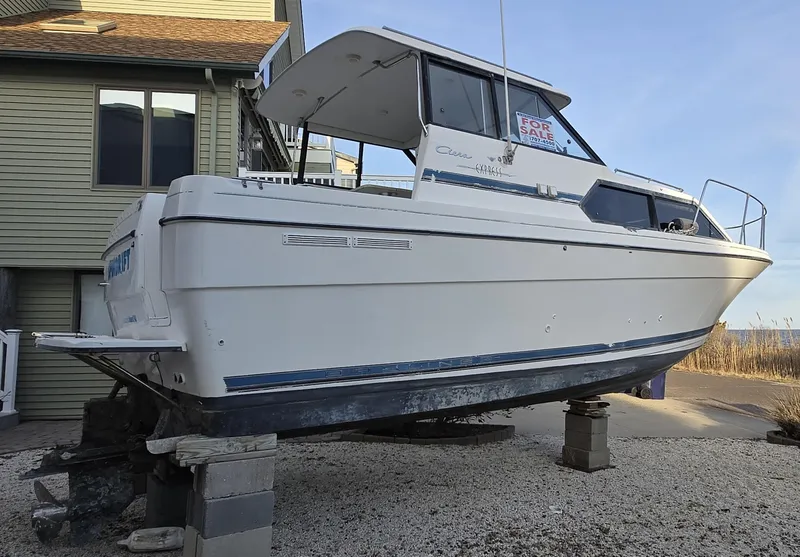 Slide: The Image of 2000 Bayliner 2859 Ciera Express boat on blocks, near a house, for sale. - 3