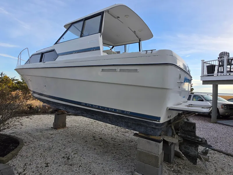 Slide: The Image of Bayliner 2859 Ciera Express 2000 model on blocks, side view, outdoors. - 30