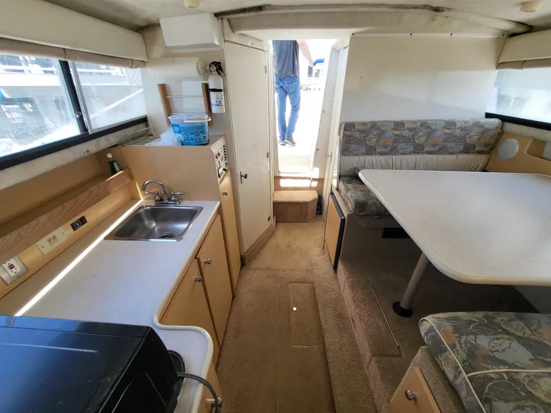 Slide: The Image of Interior of 2000 Bayliner 2859 Ciera Express with kitchenette and dining area. - 4