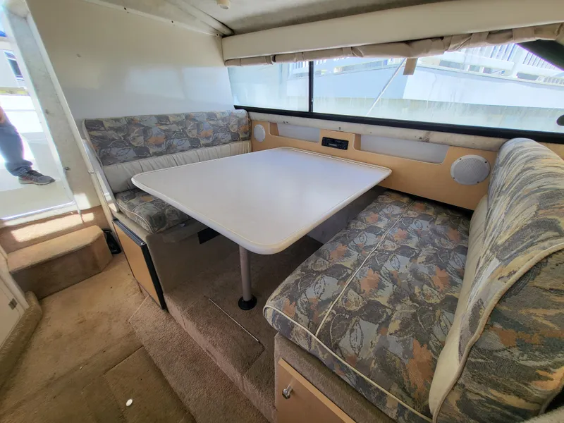 Slide: The Image of Interior of 2000 Bayliner 2859 Ciera Express with dining area and cushioned seating. - 5