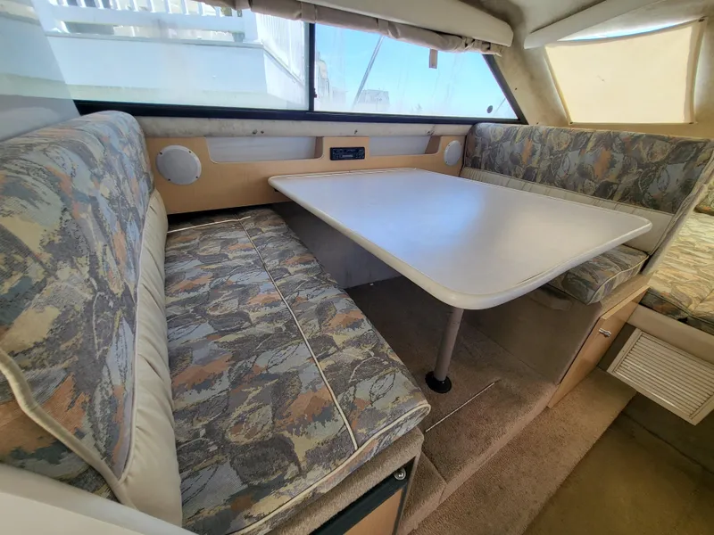 Slide: The Image of 2000 Bayliner 2859 Ciera Express interior with dining area and patterned seating. - 8