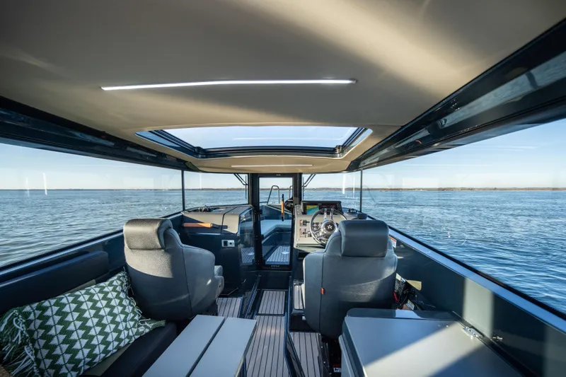 Slide: The Image of Interior of 2025 Arksen 28 boat with panoramic windows and modern seating. - 7