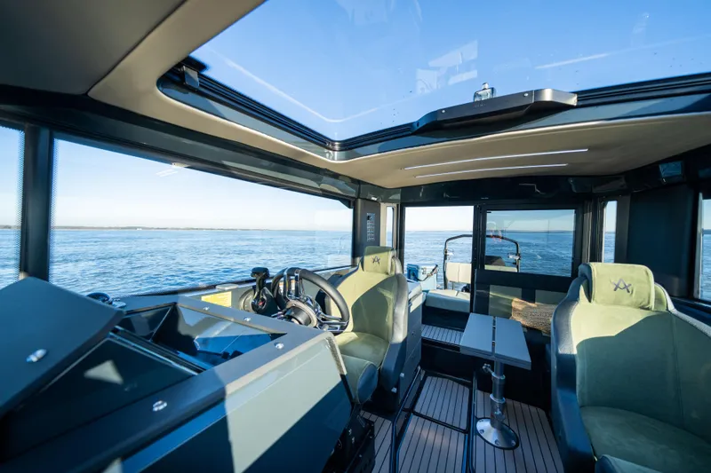 Slide: The Image of Interior view of 2025 Arksen 28 boat with modern cockpit and ocean backdrop. - 8