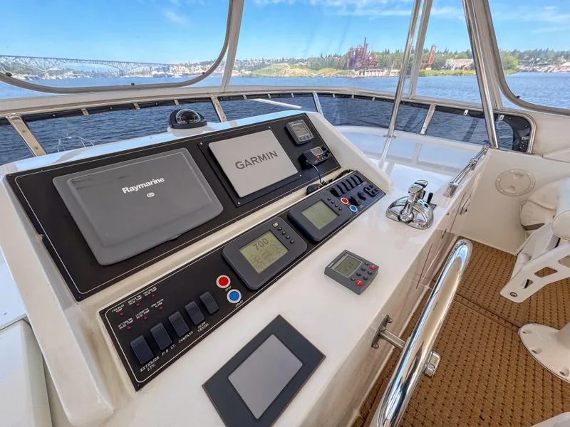 Slide: The Image of 2006 Ocean Alexander 58 Pilothouse helm with Garmin and Raymarine navigation systems. - 12