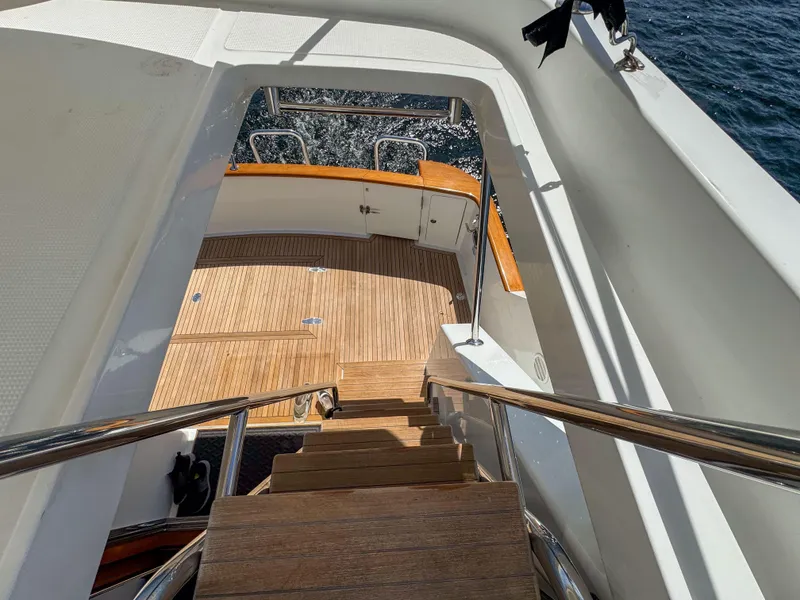 Slide: The Image of Staircase on 2006 Ocean Alexander 58 Pilothouse yacht leading to teak deck. - 17