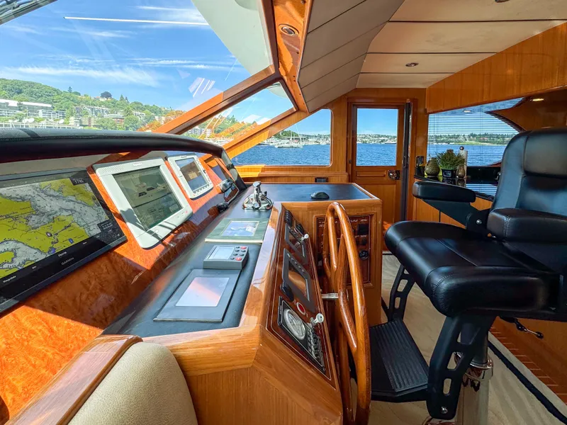 Slide: The Image of Pilothouse of 2006 Ocean Alexander 58, featuring navigation equipment and captain's chair. - 23
