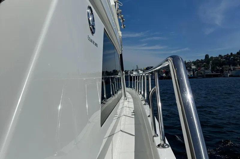 Slide: The Image of Side deck view of 2006 Ocean Alexander 58 Pilothouse yacht on the water. - 4