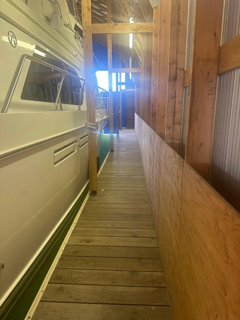 Slide: The Image of 2006 Ocean Alexander 58 Pilothouse yacht docked in a wooden marina. - 41