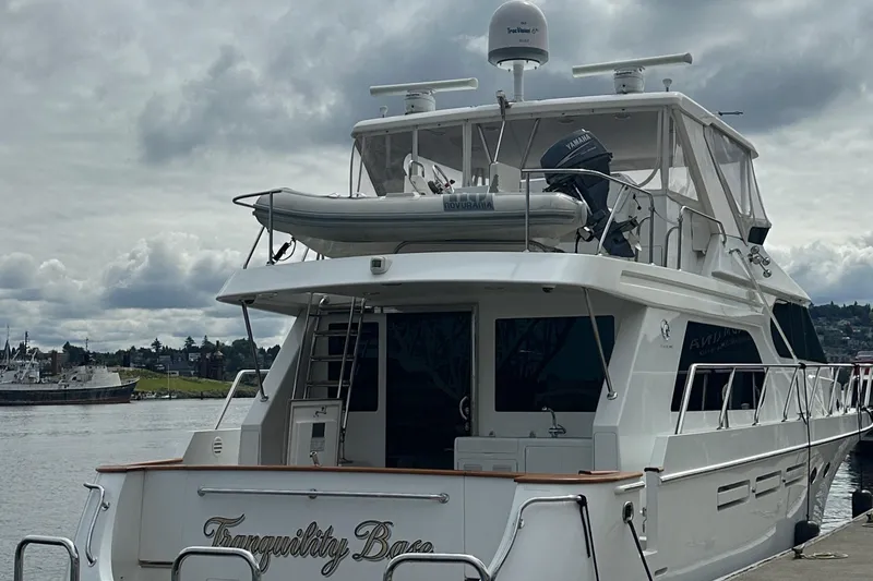 Slide: The Image of 2006 Ocean Alexander 58 Pilothouse yacht docked, rear view with dinghy on top. - 5