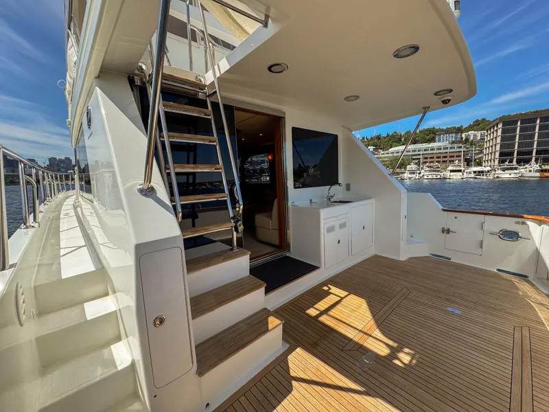 Slide: The Image of 2006 Ocean Alexander 58 Pilothouse yacht deck with stairs and waterfront view. - 7