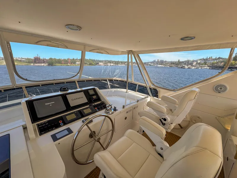 Slide: The Image of 2006 Ocean Alexander 58 Pilothouse helm with panoramic water views and modern navigation equipment. - 9