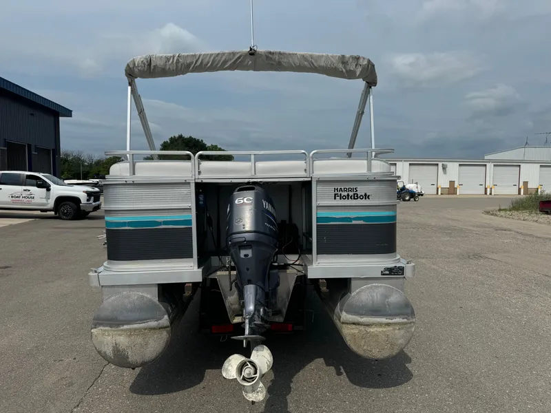 Slide: The Image of 1993 Harris 200 Classic pontoon boat with Yamaha 60C outboard motor, parked outdoors. - 3