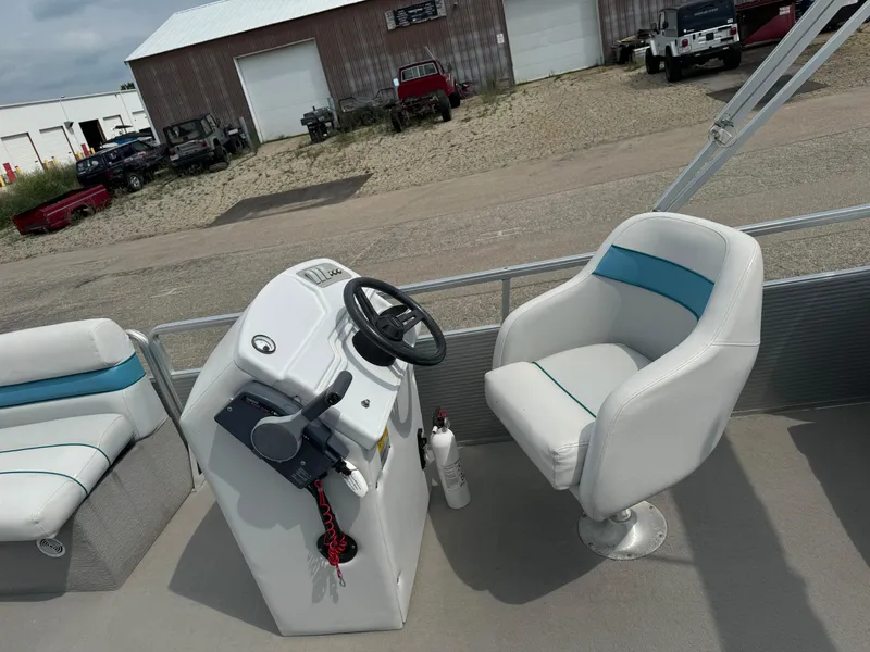 Slide: The Image of 1993 Harris 200 Classic boat interior with steering console and white seating. - 8