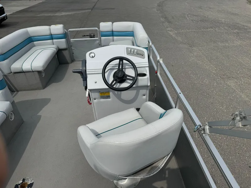 Slide: The Image of 1993 Harris 200 Classic pontoon boat interior with steering wheel and seating. - 9