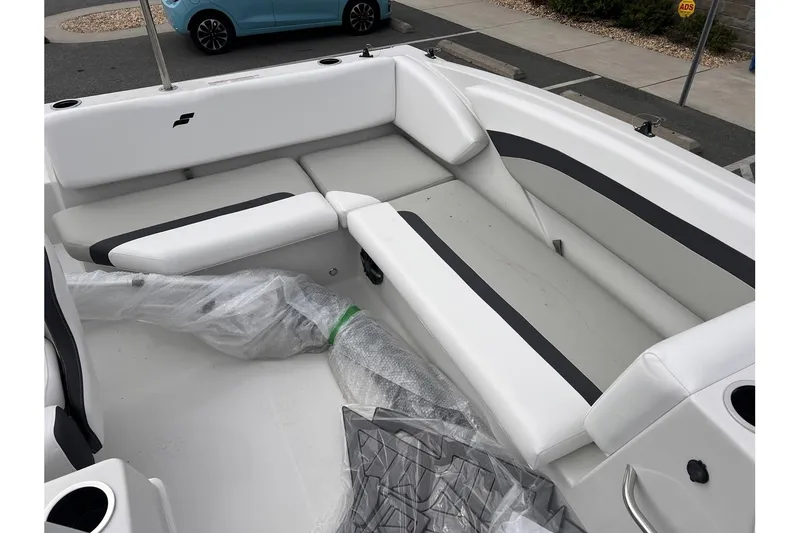 Slide: The Image of 2024 Starcraft SVX 171 OB boat interior with white and black seating. - 10