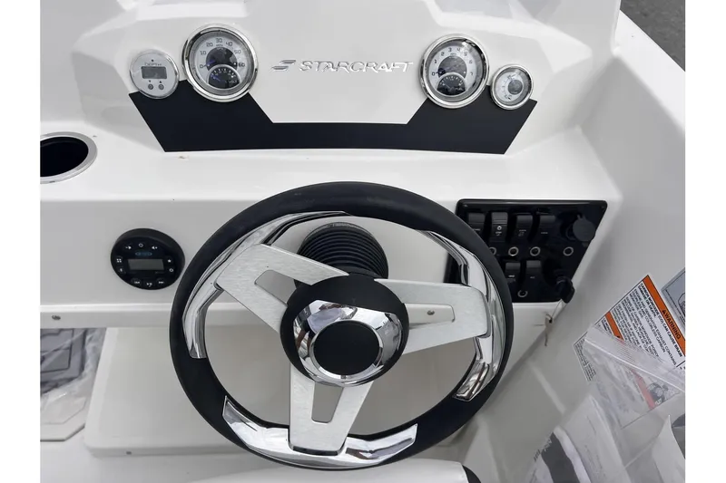Slide: The Image of 2024 Starcraft SVX 171 OB boat dashboard with steering wheel and gauges. - 12