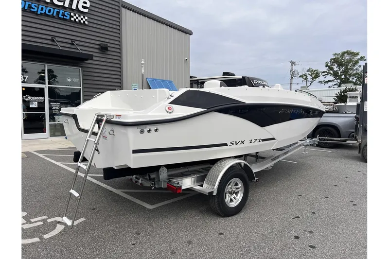 Slide: The Image of 2024 Starcraft SVX 171 OB boat on a trailer outside a dealership. - 3