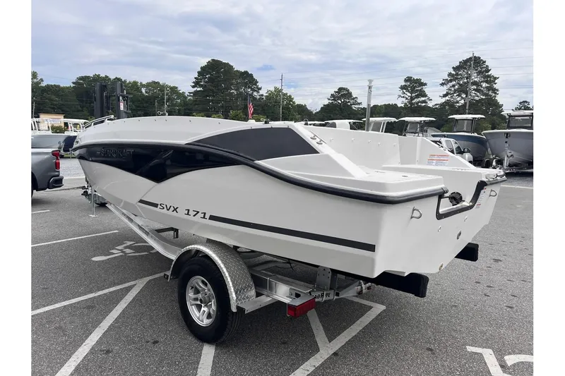 Slide: The Image of 2024 Starcraft SVX 171 OB boat on a trailer in a parking lot. - 5