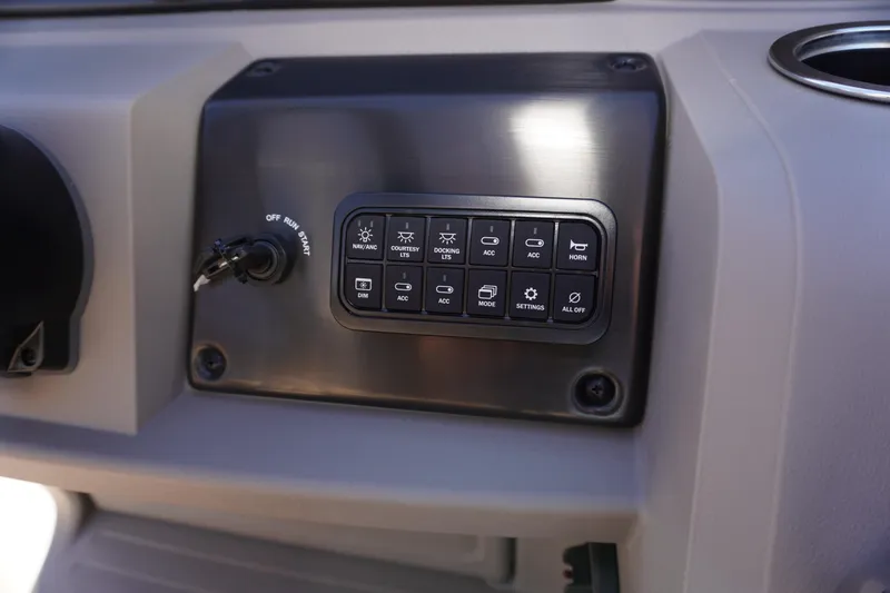 Slide: The Image of Control panel of 2024 Sun Tracker Party Barge 20 DLX with various function buttons. - 11