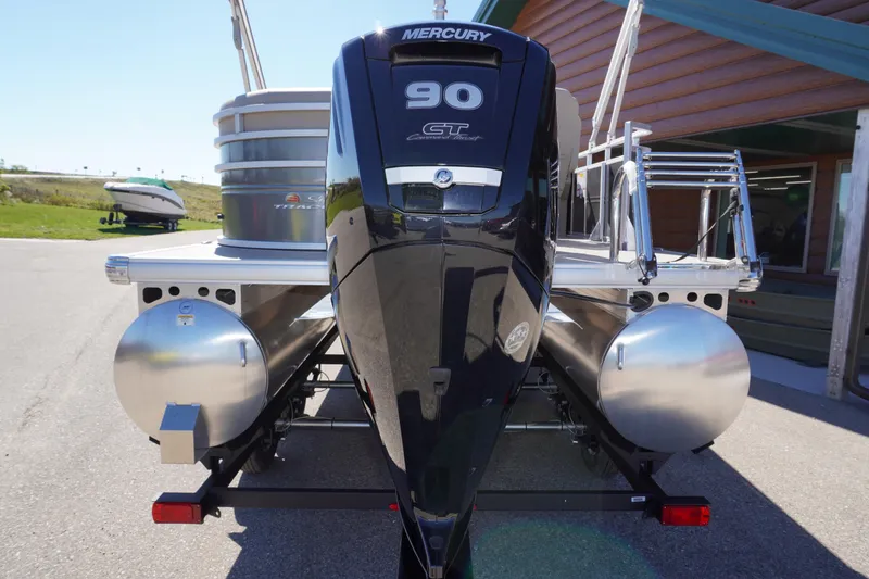 Slide: The Image of 2024 Sun Tracker Party Barge 20 DLX with Mercury 90 engine, parked outdoors. - 14