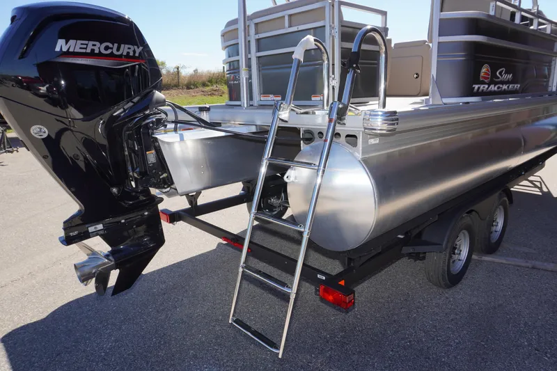 Slide: The Image of 2024 Sun Tracker Party Barge 20 DLX with Mercury engine and ladder on trailer. - 16