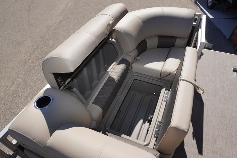 Slide: The Image of 2024 Sun Tracker Party Barge 20 DLX seating with storage compartment open. - 2