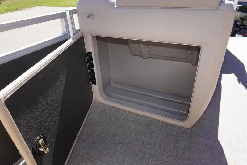 Slide: The Image of 2024 Sun Tracker Party Barge 20 DLX storage compartment with open door, showcasing interior space. - 3
